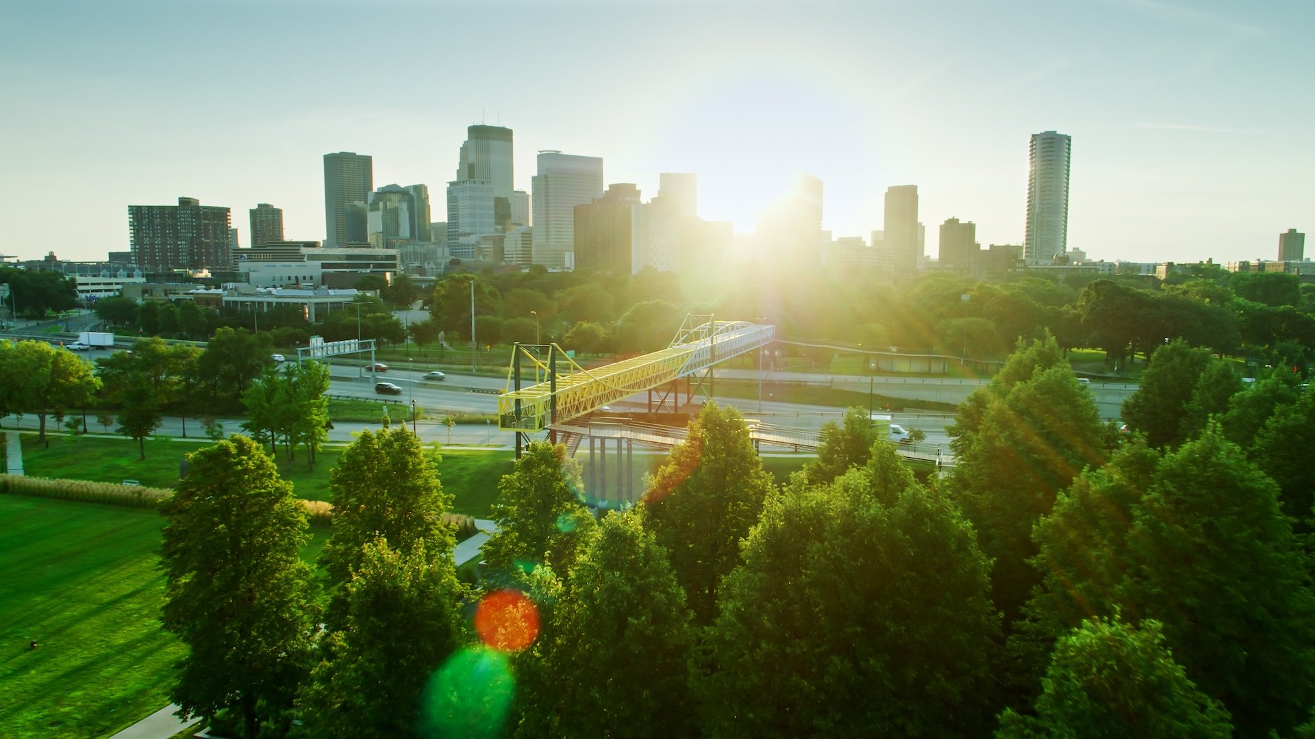 Aerial shot of Minneapolis, Minnesota at sunrise, looking across Interstate 394 and Loring Park towards the Downtown Skyline.