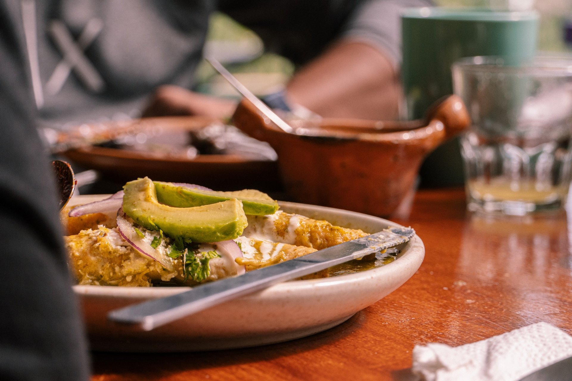 Enchiladas verdes in Mexican restaurant on a wooden background