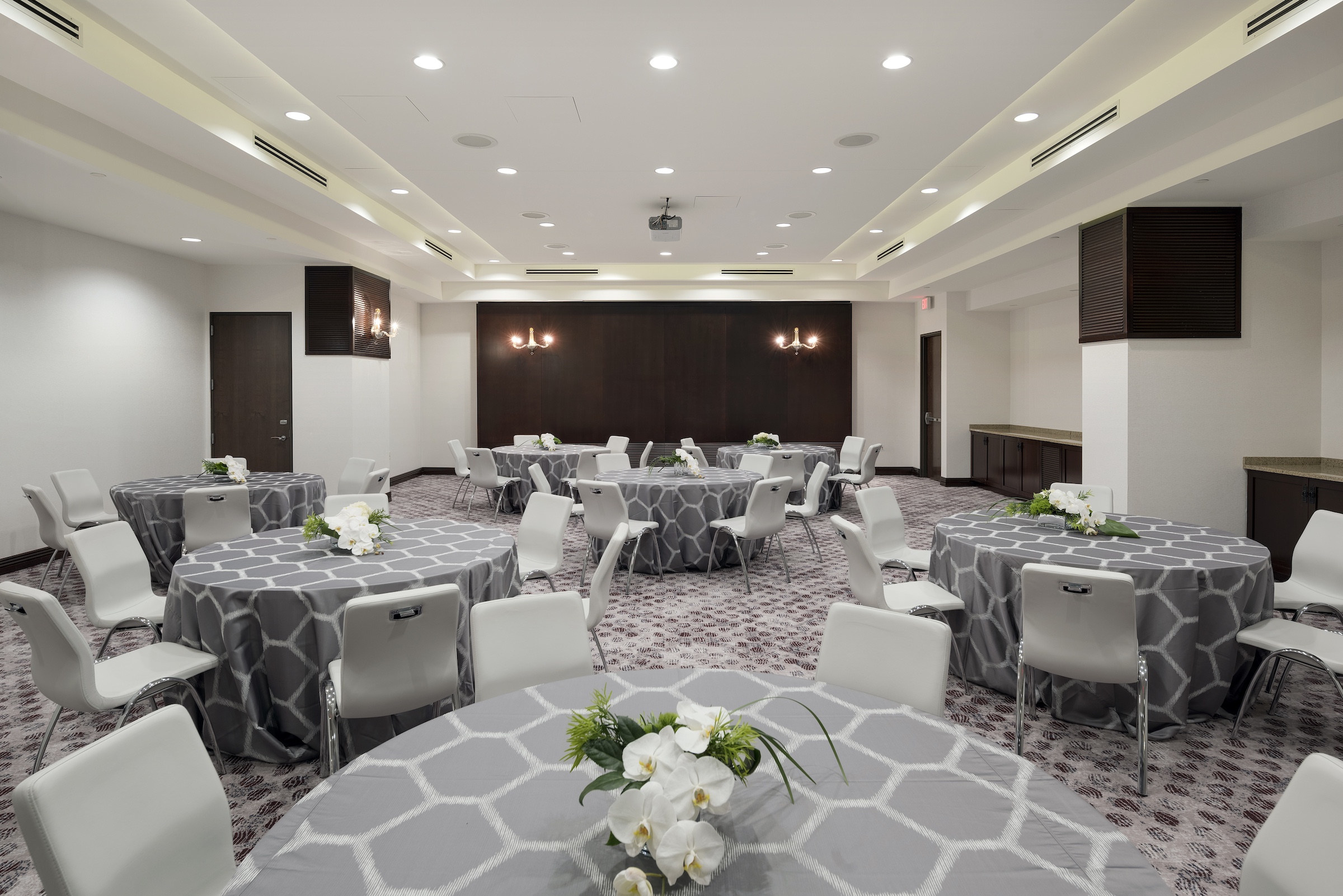 Round tables with grey cloth and chairs in a modern stylish meeting space, Grand Salon of Hotel Ivy