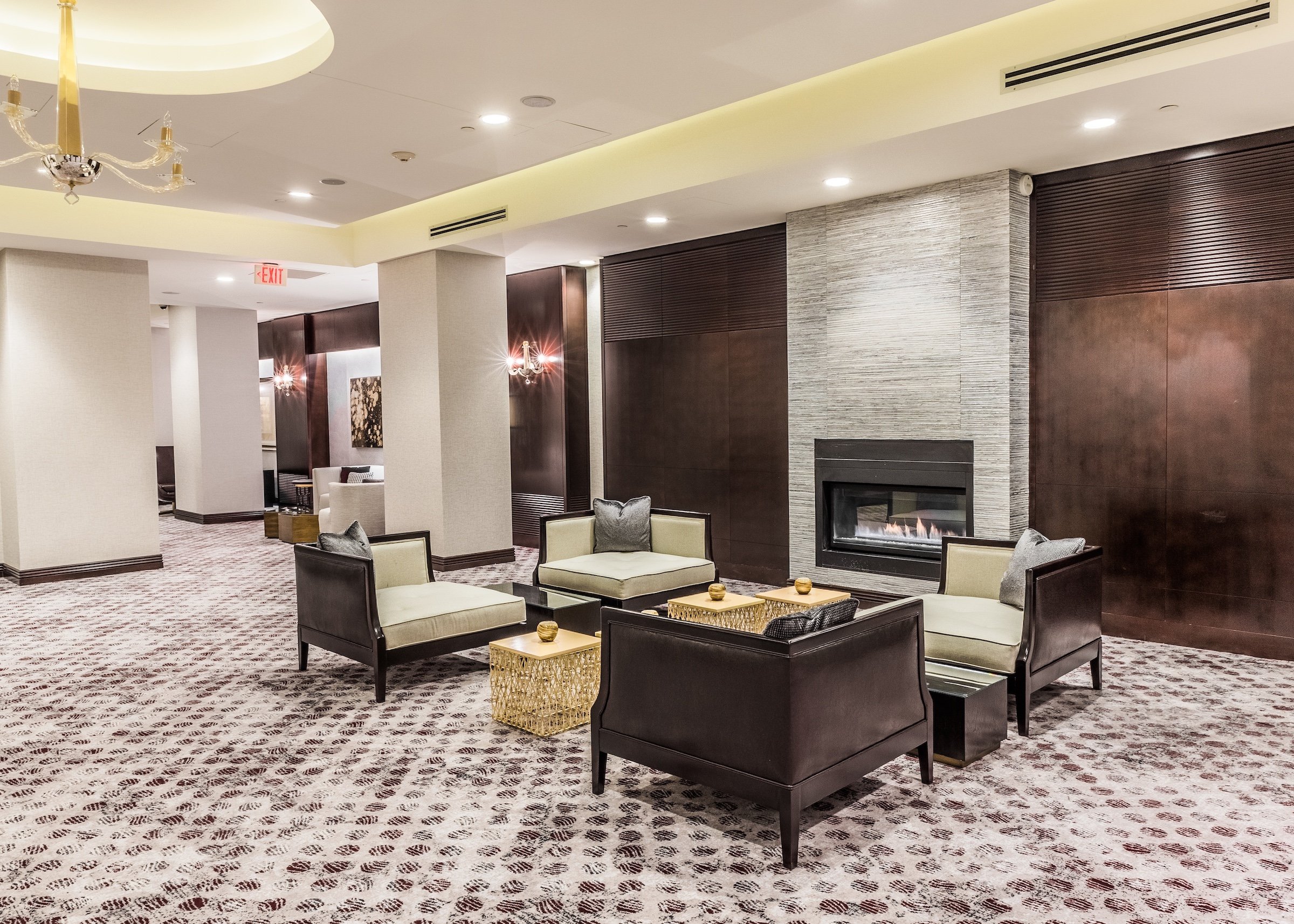 Brown leather couch and tea tables in a large bright venue with modern interior and fireplace, Pre-function Space at Hotel Ivy