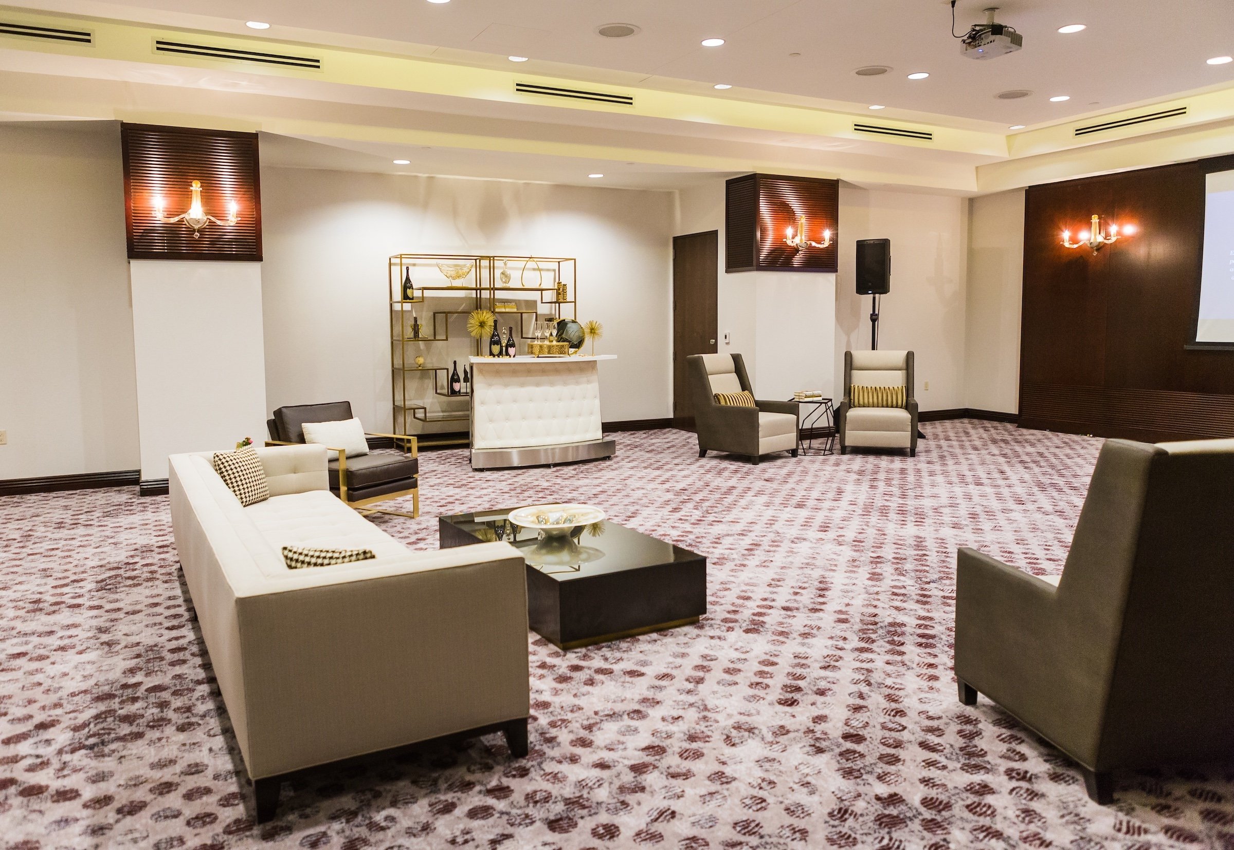 Couches, chairs, reception, and a tea table in a large meeting space with white modern interior, Pre-function Space at Hotel Ivy