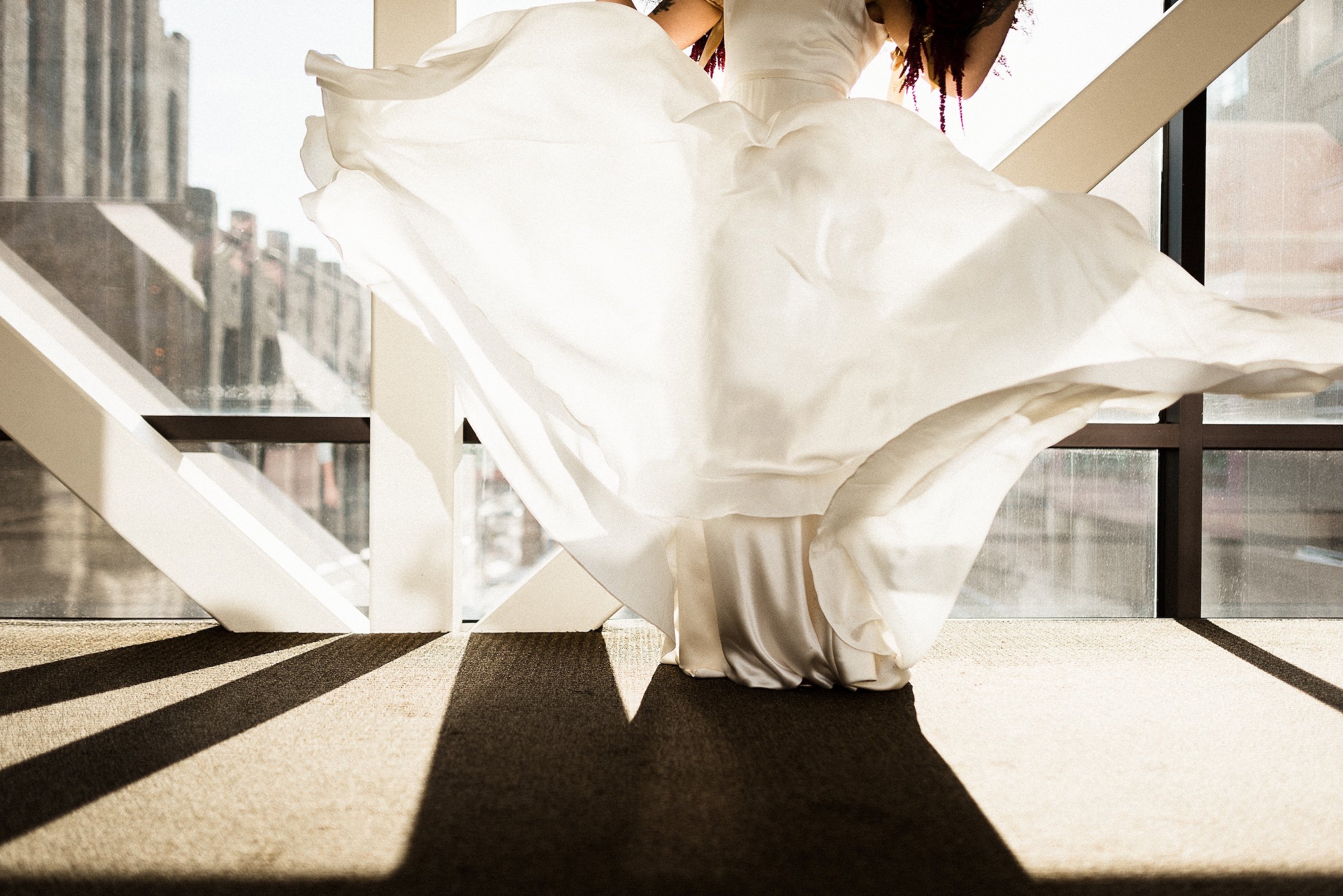 A photoshoot of a bride's lower body to show her windy white wedding dress at Hotel Ivy