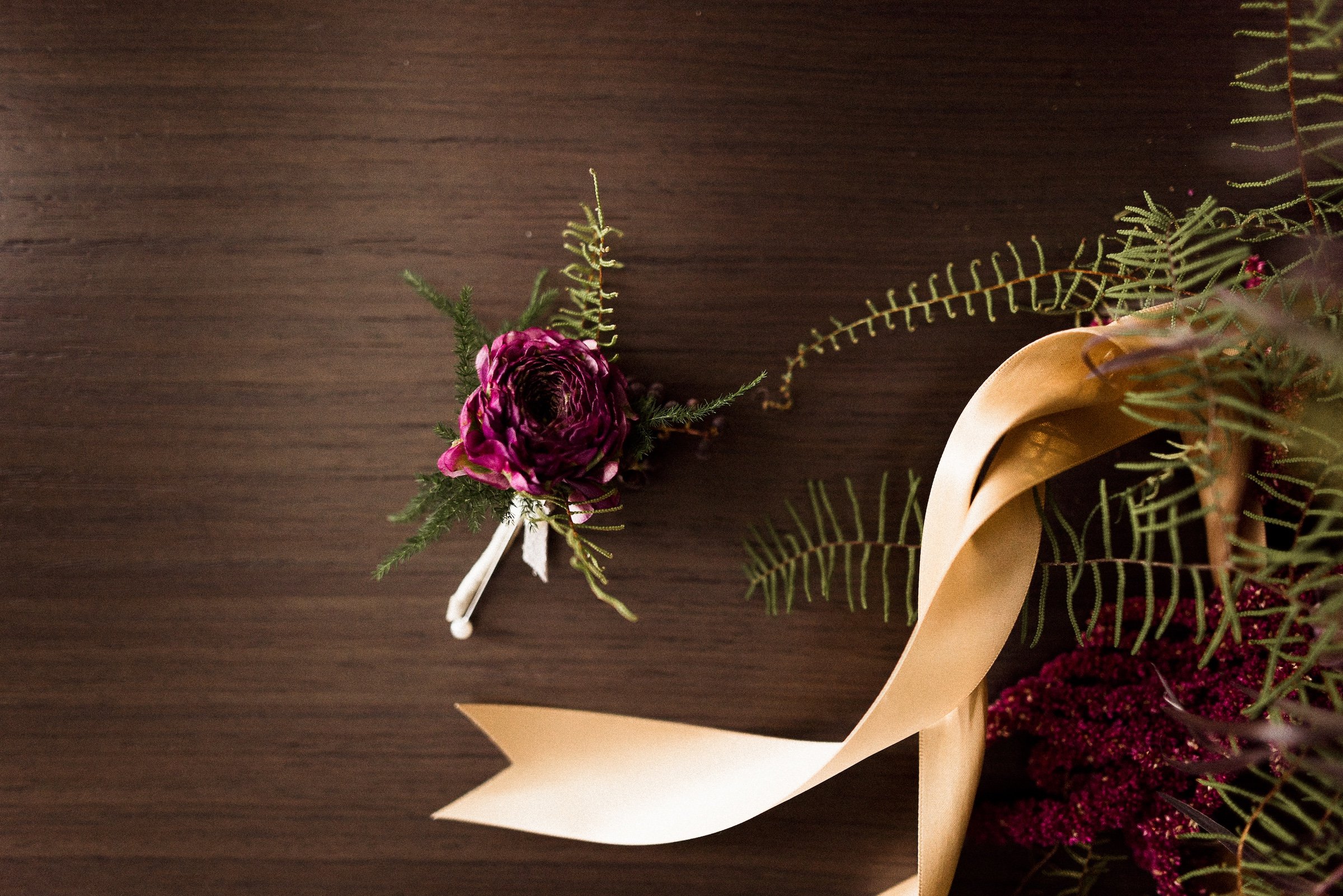 A purple rose and plants for decorations on dark wooden table at Hotel Ivy