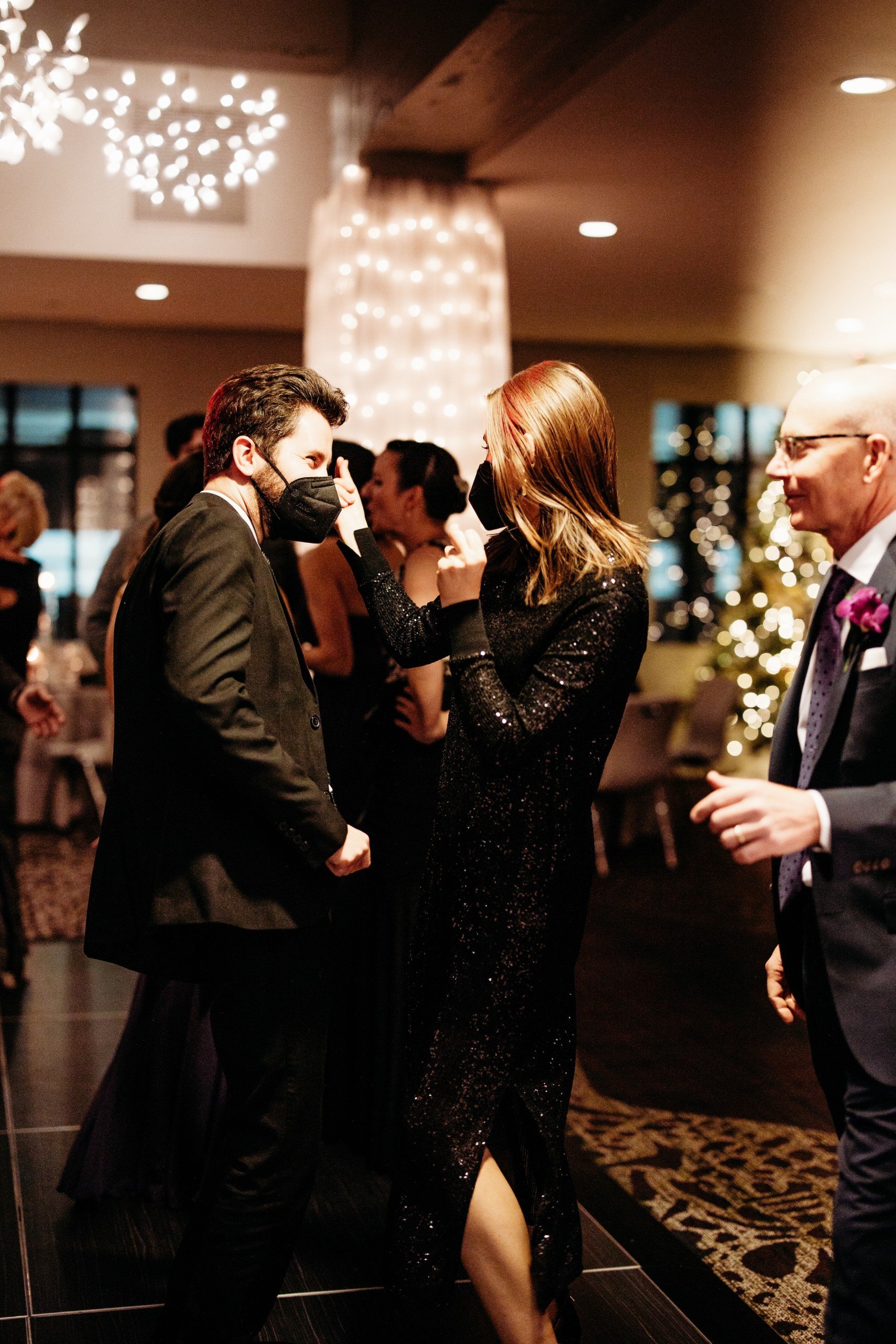 Two guests in formal attire share a joyful moment while dancing at Granby and Sprung's wedding event in the Grand Studio at Hotel Ivy.