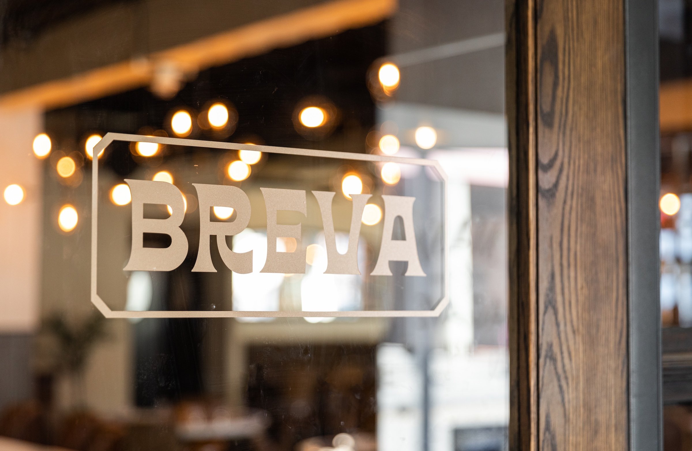 Ivory colour of Breva Logo sticker on the glass door from Hotel Ivy