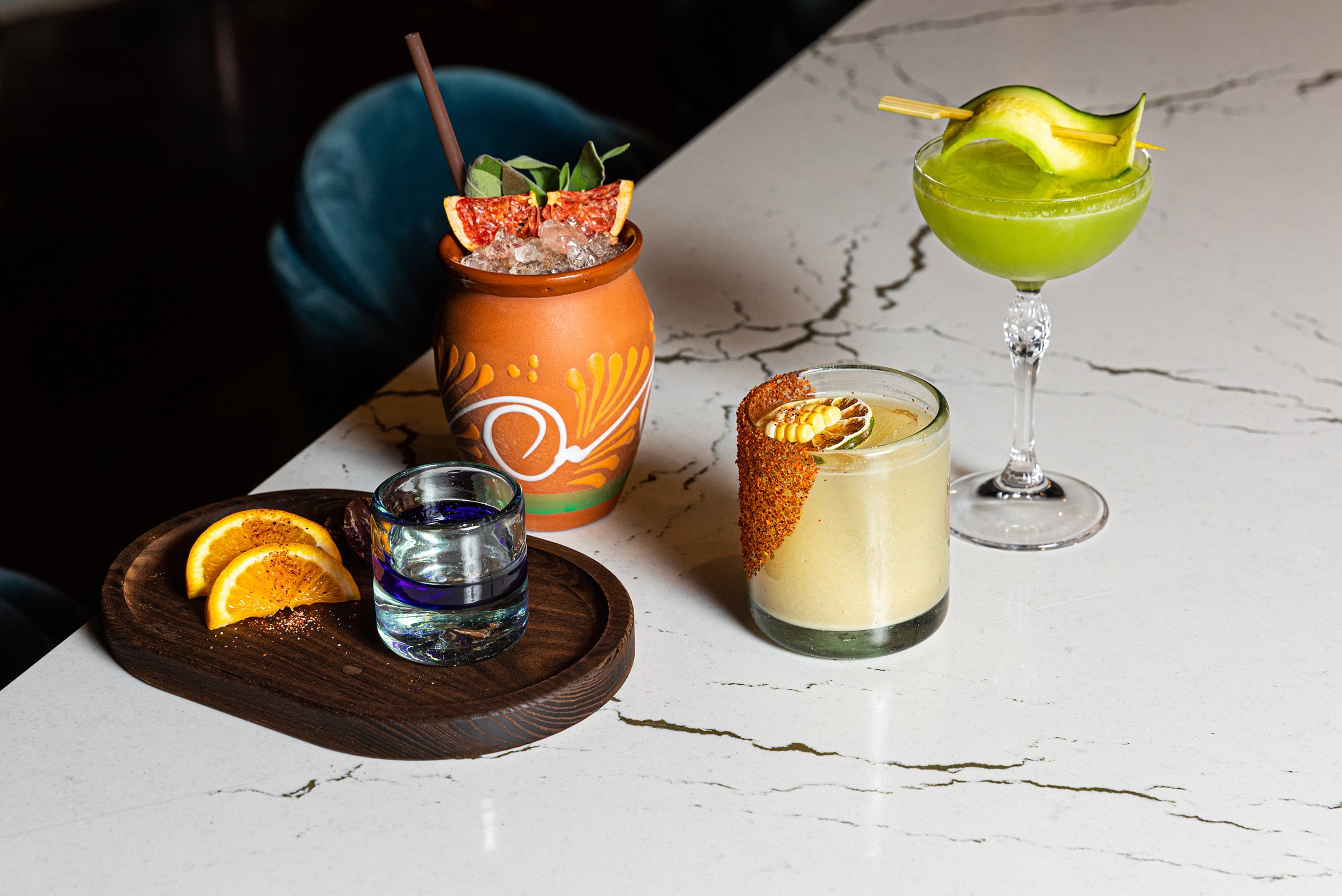 Colourful cocktails on a white marble table at Masa & Agave of Hotel Ivy