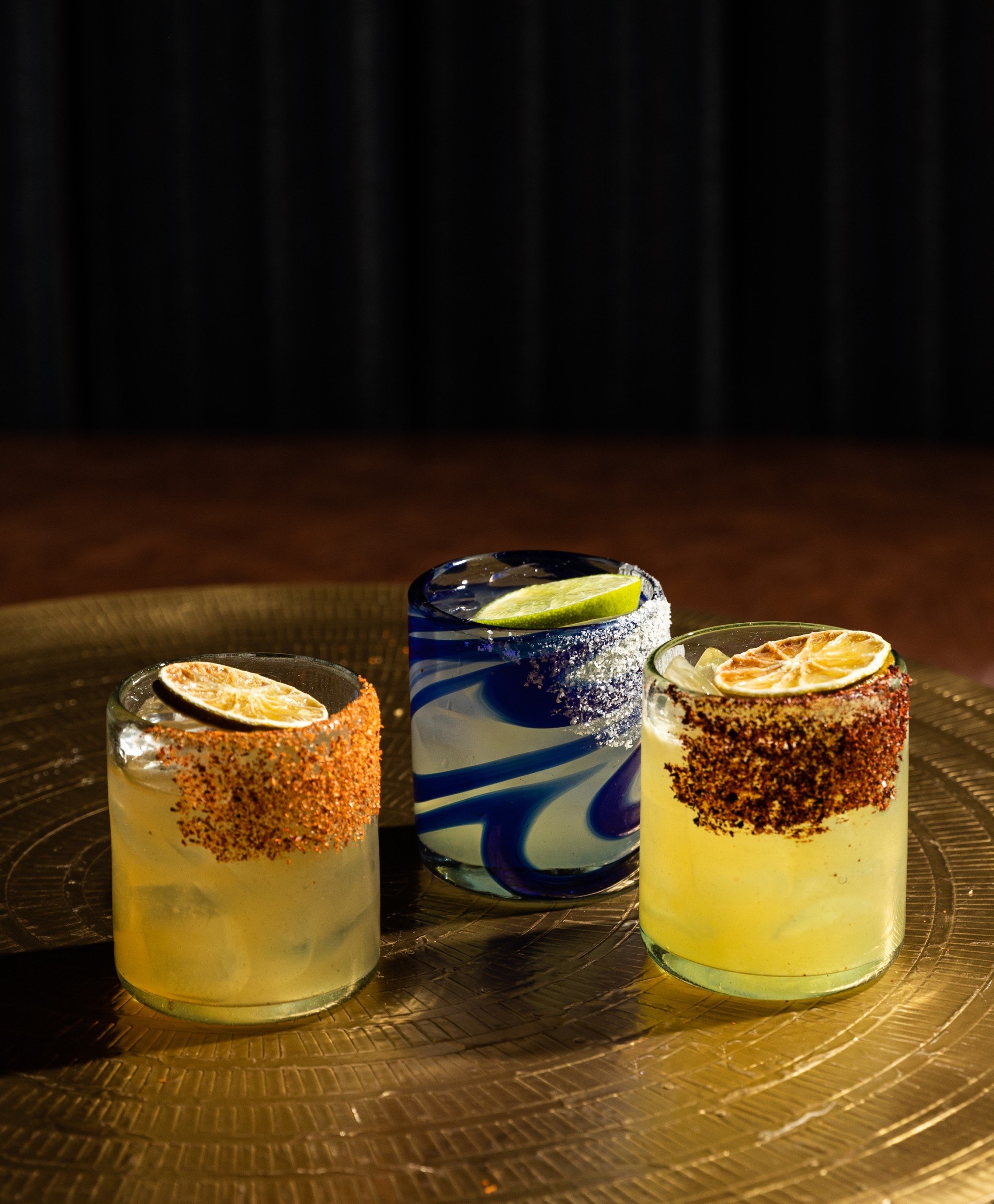 Three different types of margarita on a golden table at Masa & Agave, Hotel Ivy