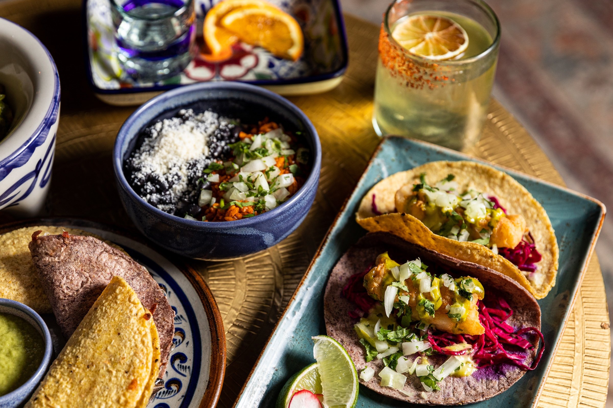 Tacos, Mexican rice and cocktails on a authentic rattan table at Masa & Agave of Hotel Ivy