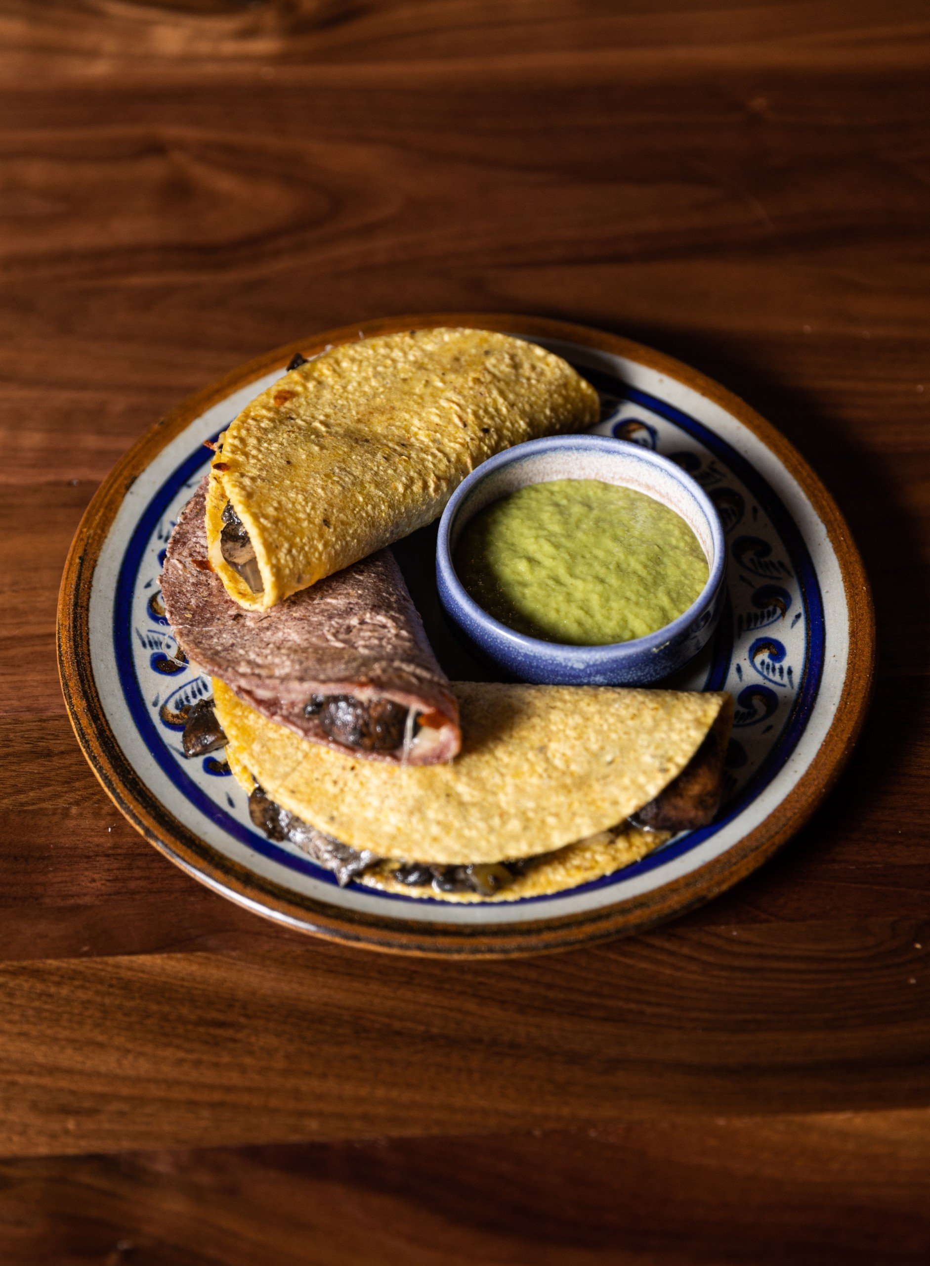 Tacos and guacamole on a unique plate from a wooden table at Masa & Agave from Hotel Ivy