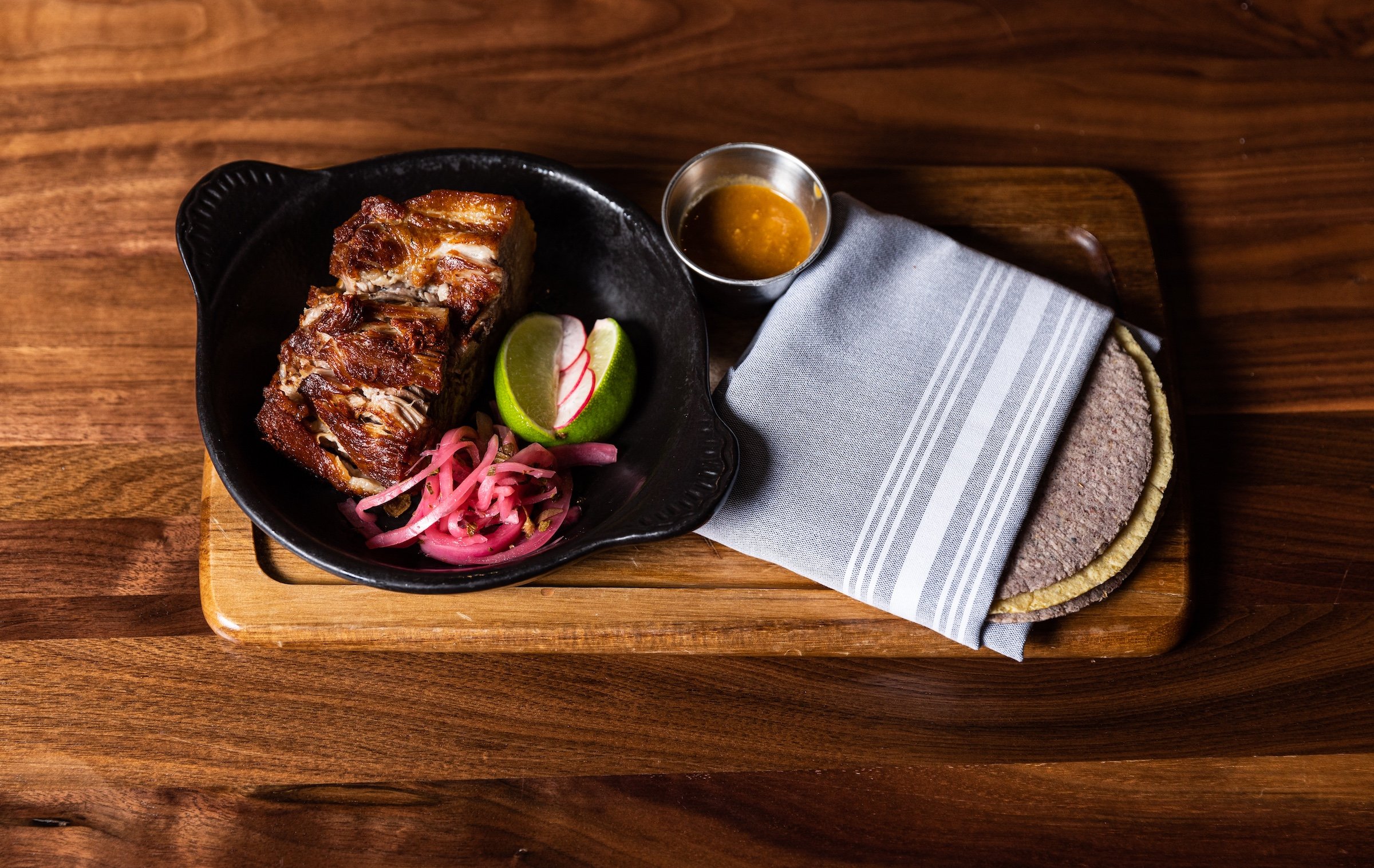 Port Carnitas on a wooden table at Masa & Agave, Hotel Ivy