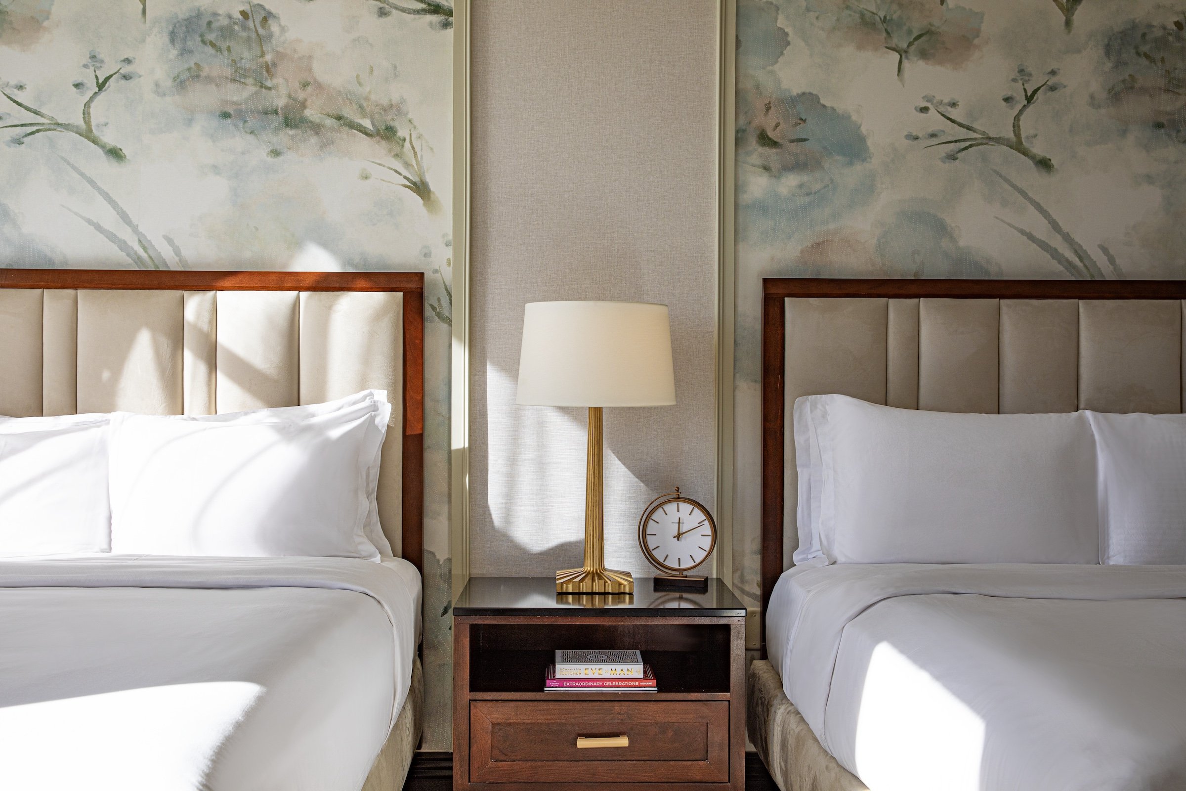 Large two beds with white sheets behind the stylish wall at Hotel Ivy