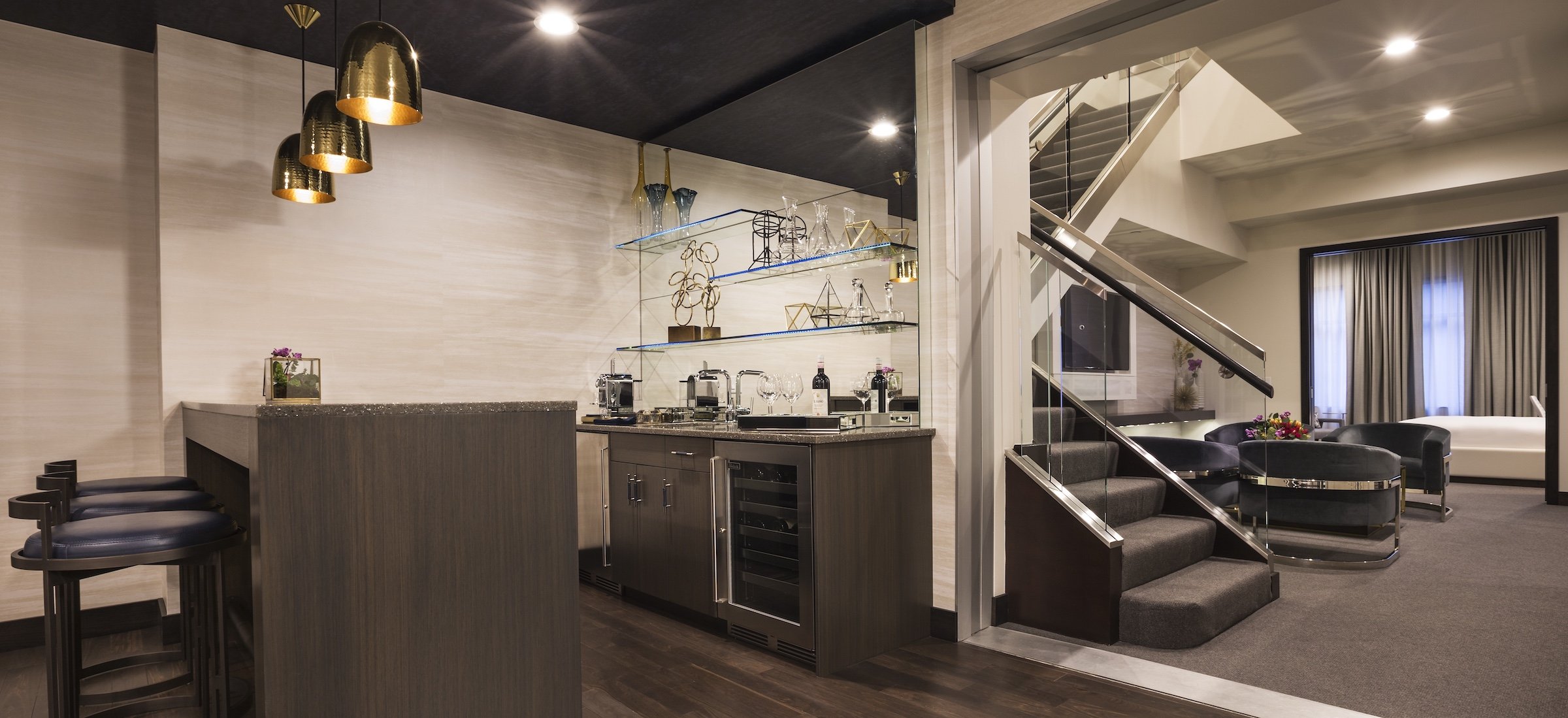 A Kitchen area with high dining tables next to stairs at Penthouse Suite of Hotel Ivy