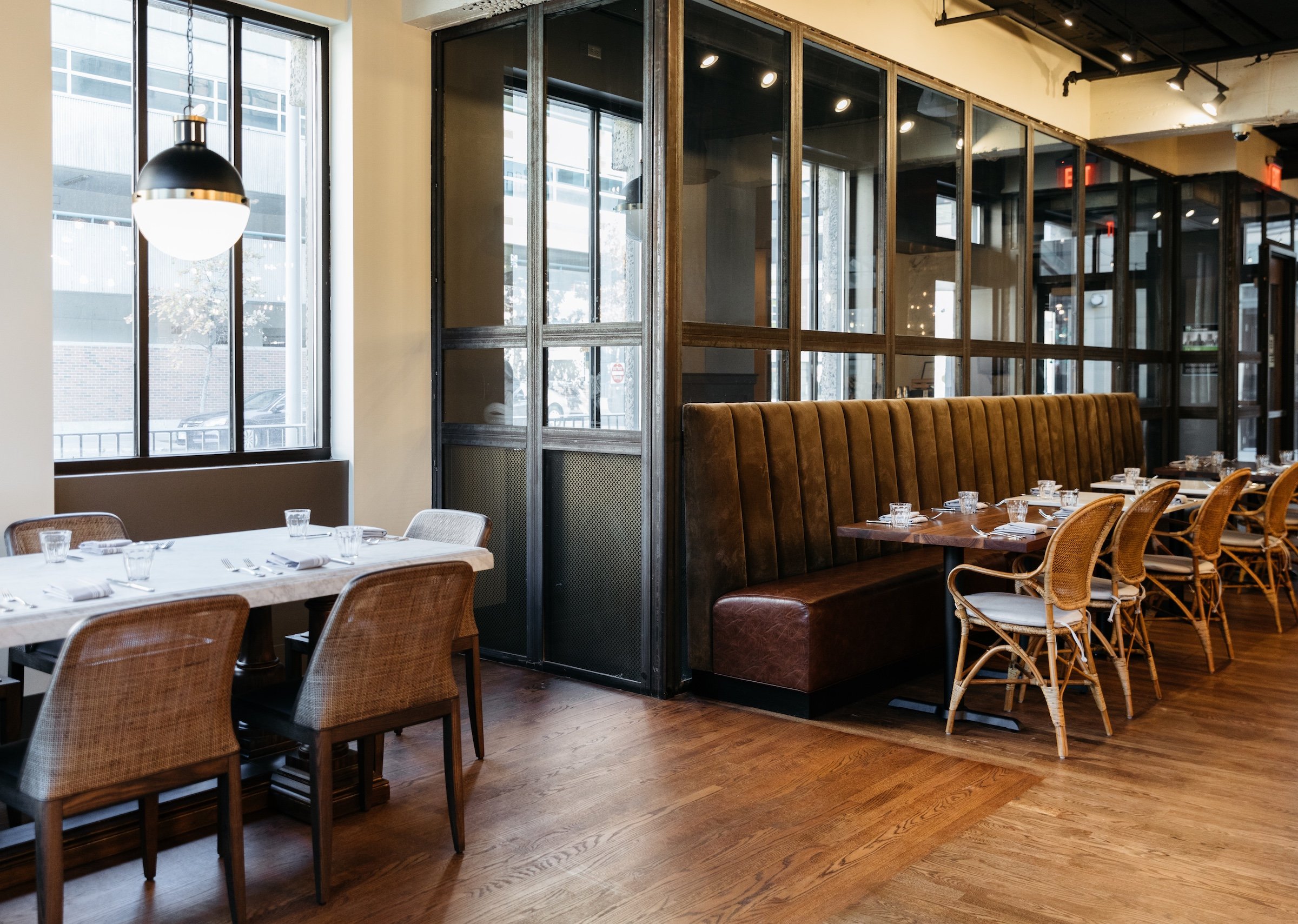 large glass windows and entrance door next to a dining area, Breva from Hotel Ivy